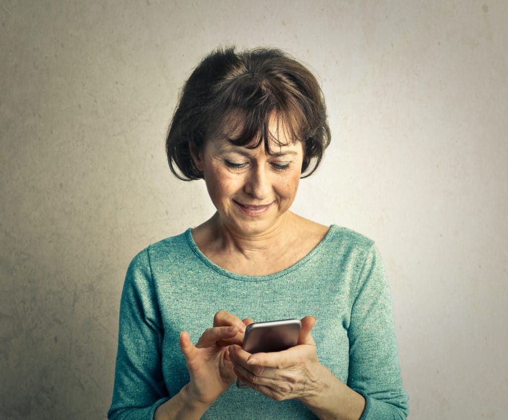 Older woman looking at her phone