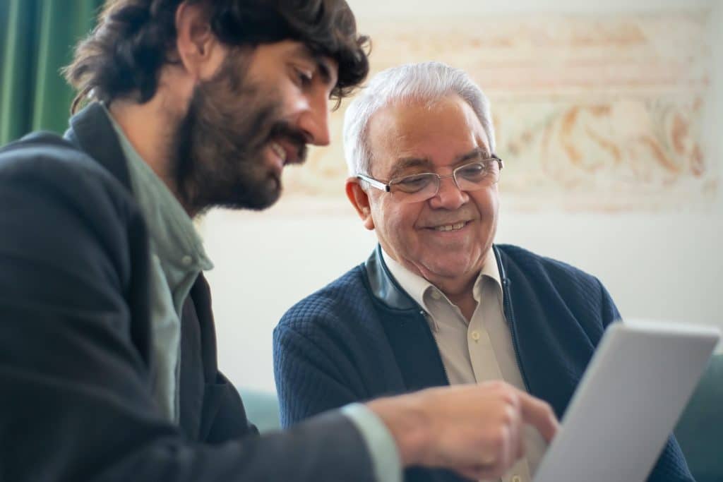 An agent helps a senior customer understand insurance