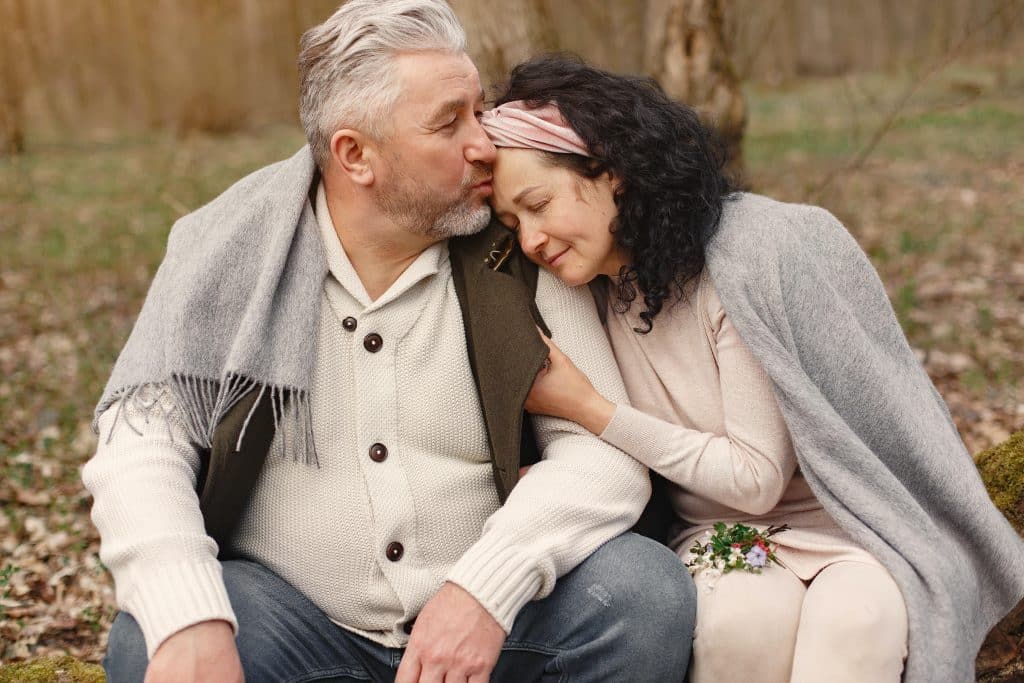 Elderly couple embracing in a park